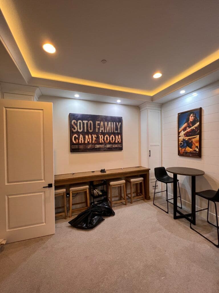 Family game room featuring seating, a large sign, and modern decor elements.